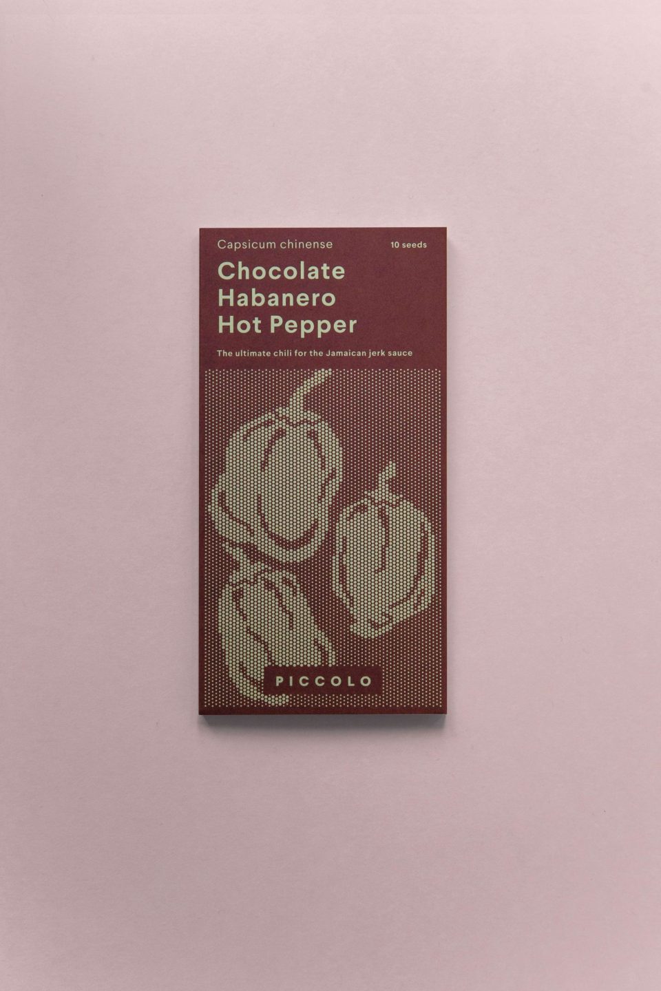 Smeđa kutija sjemenki chocolate habanero čili papričica na rozoj podlozi