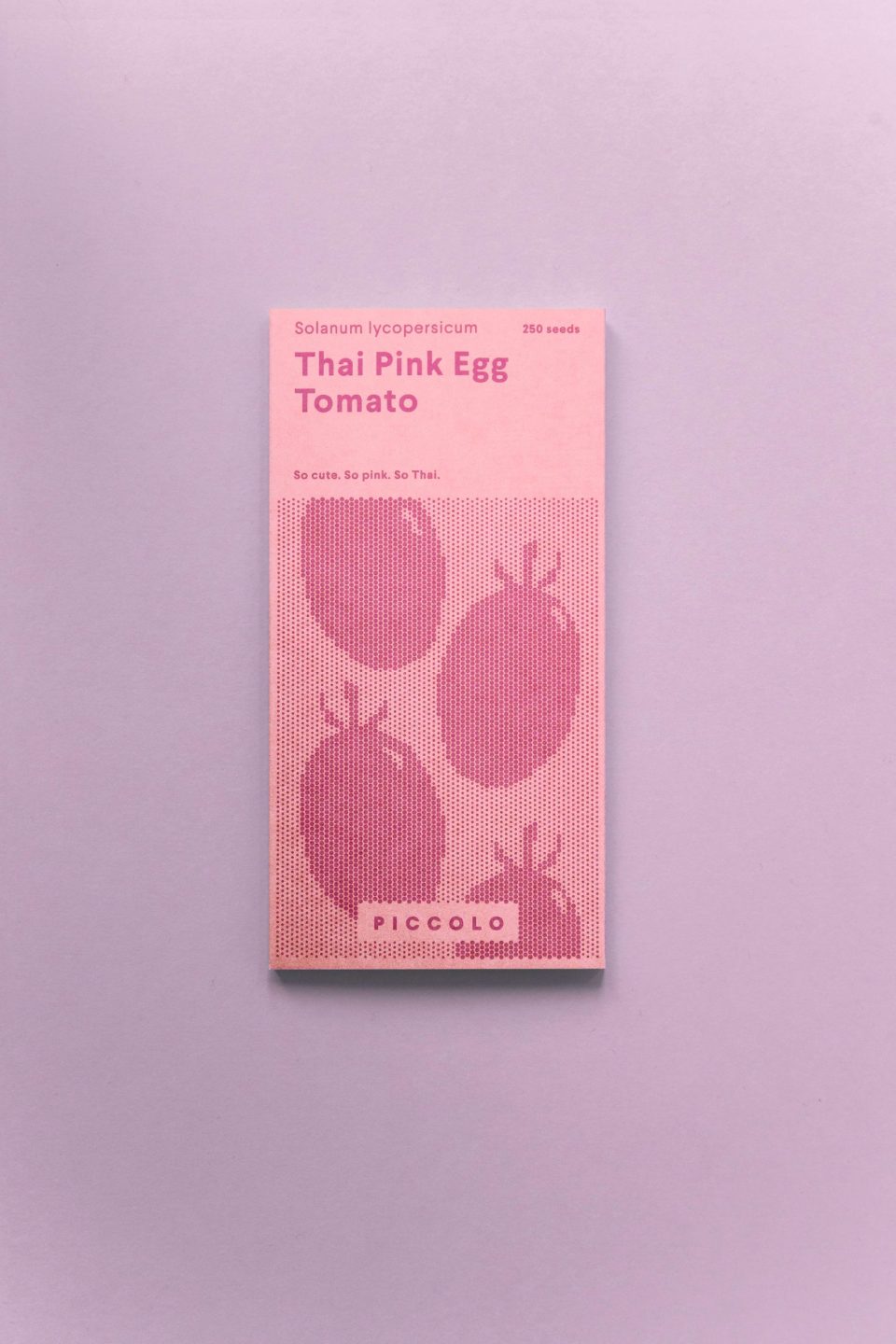 Roza kutija sjemenki rajčica thai pink egg na ljubičastoj podlozi