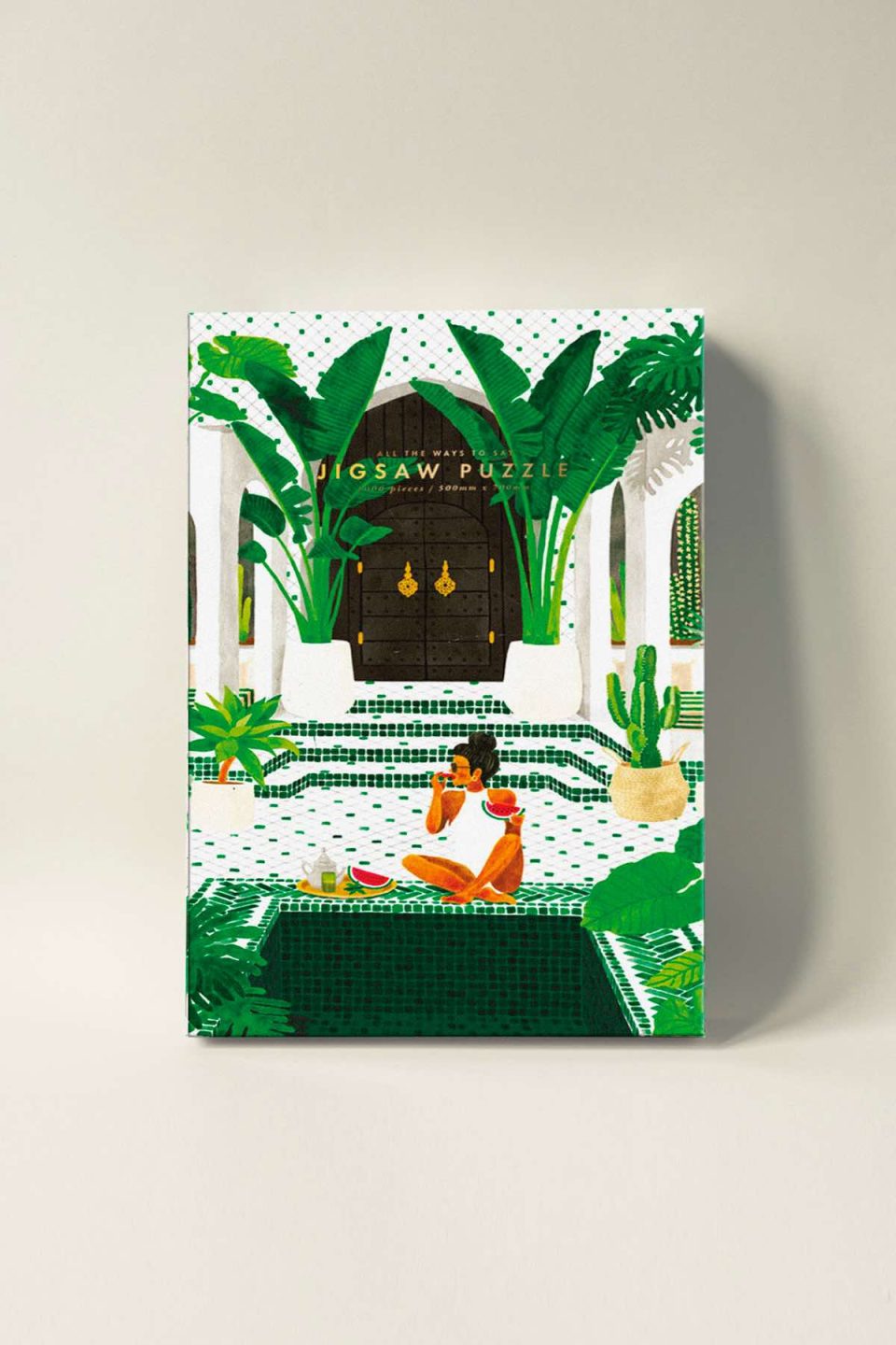 Kutija puzli s motivom žene koja jede lubenicu uz bazen u lijepoj vili popločanoj pločicama s arapskim uzorcima, okružena s puno biljaka i palmi