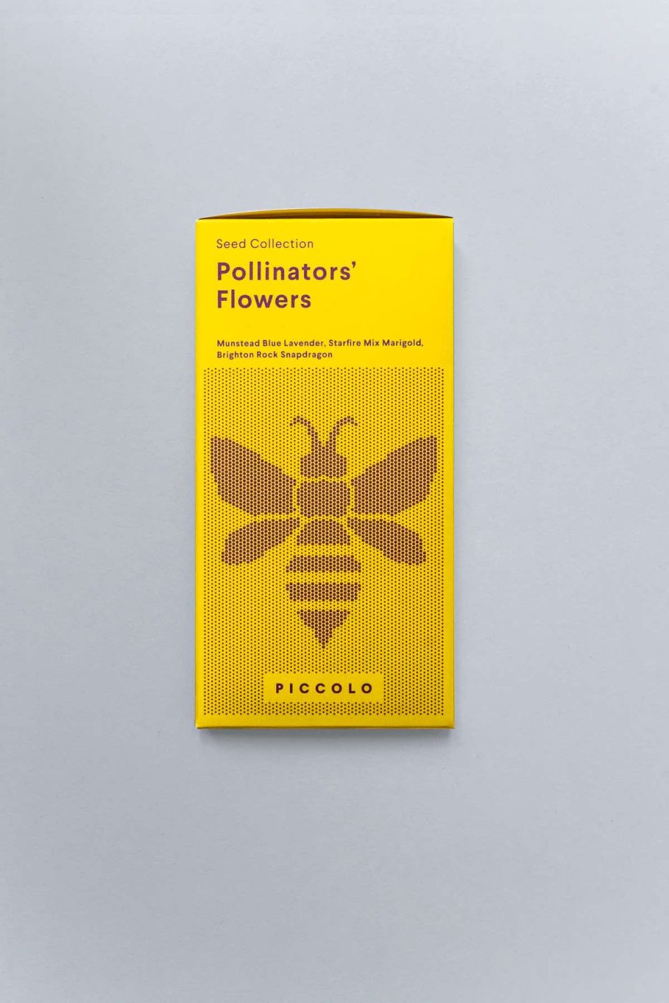 Žuta kutija sjemenki s cvijećem koje služi pčelama za skupljanje peludi na sivoj podlozi